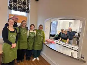A
  group
  of
  people
  wearing
  aprons
  Description
  automatically
  generated
