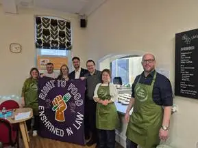 A
  group
  of
  people
  wearing
  aprons
  Description
  automatically
  generated