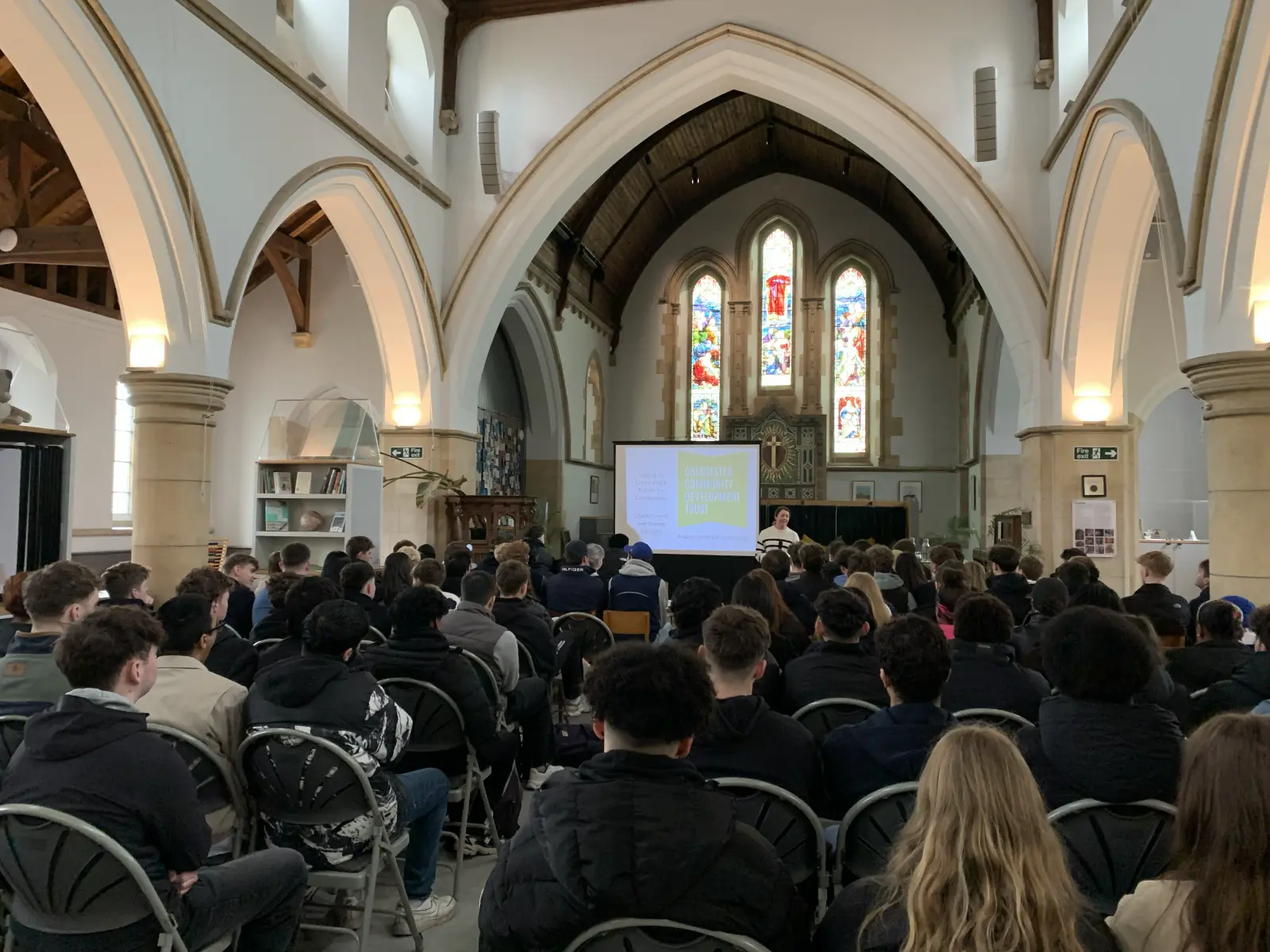 A
  group
  of
  people
  in
  a
  church
  Description
  automatically
  generated