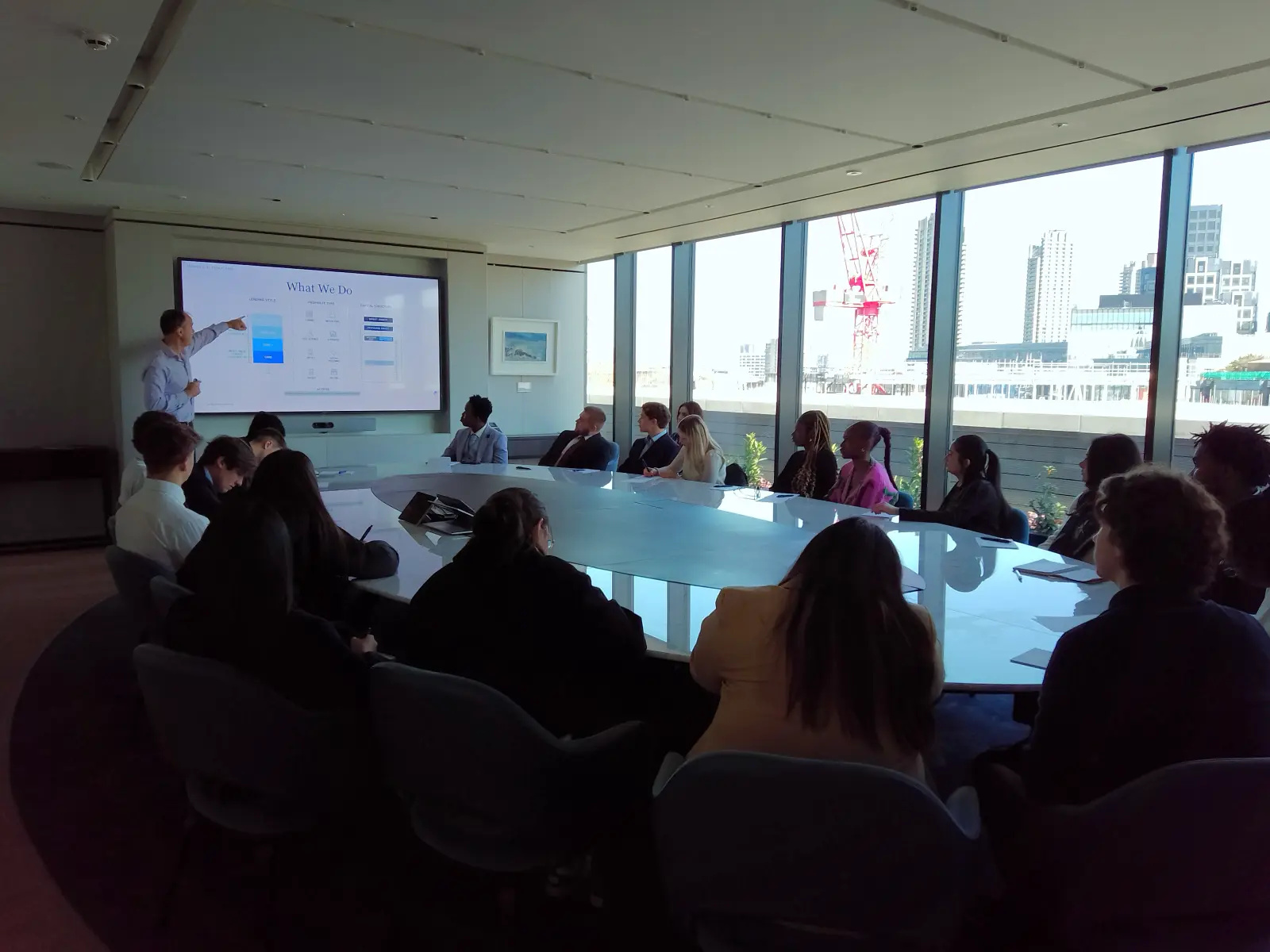 A
  group
  of
  people
  sitting
  around
  a
  table
  Description
  automatically
  generated
