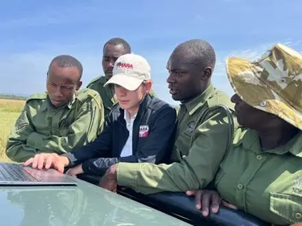 A
  group
  of
  people
  in
  uniform
  looking
  at
  a
  computer
  AI-generated
  content
  may
  be
  incorrect.