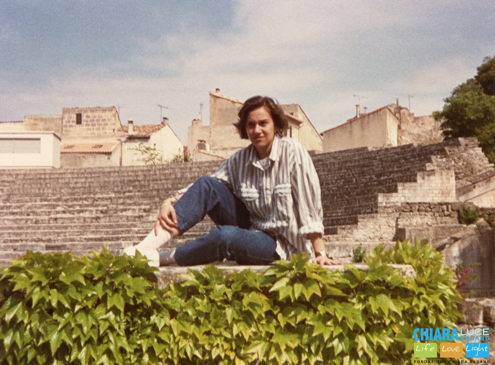 Chiara Badano sitting at an ancient site