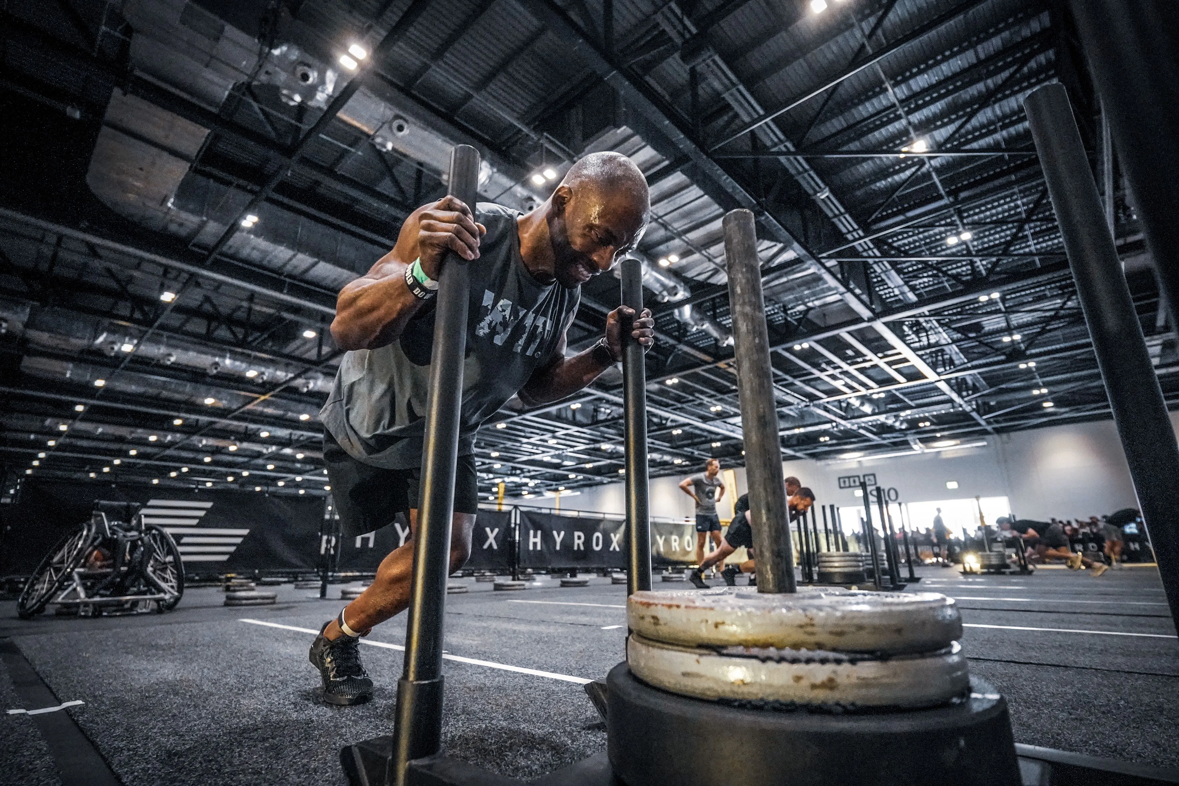 Amputee men pushing weights on the ground