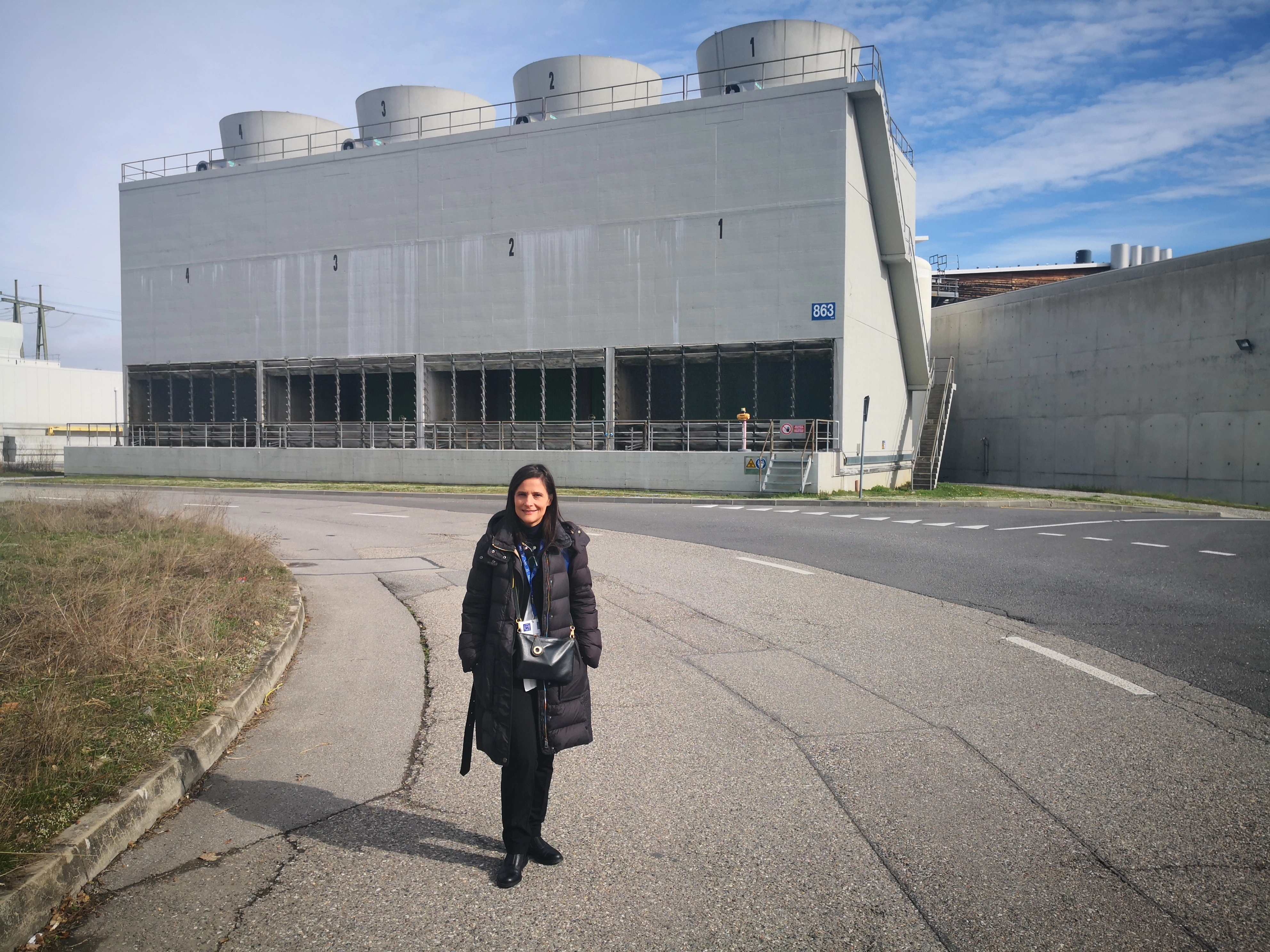 CERN Alumna Maria Carmen Mordo Testa in front of CERN ATLAS cooling towers