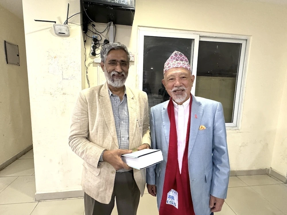 Yohei Sasakawa with Executive Chairman Dharmendra Jha of Rastriya Samachar Samiti (RSS), Nepal’s national news agency, at its headquarters in the capital.