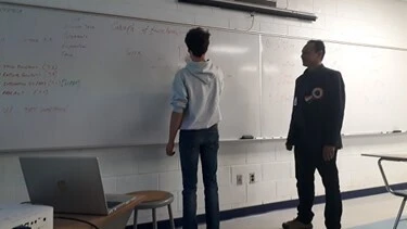 Mohan Sharma supervising a student