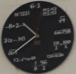 A clock with mathematical symbols